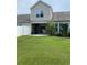 Backyard showcasing the green lawn and a partial view of the house with a white fence at 156 Parmelee Dr. # B, Murrells Inlet, SC 29576