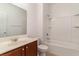 Clean bathroom featuring a vanity, toilet, and shower-tub combo with white tile at 156 Parmelee Dr. # B, Murrells Inlet, SC 29576