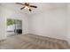 Bedroom featuring plush carpet, sliding glass doors to the patio, and ample natural light at 156 Parmelee Dr. # B, Murrells Inlet, SC 29576