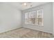 Neutral bedroom with plush carpet, a ceiling fan, and three large windows offering natural light at 156 Parmelee Dr. # B, Murrells Inlet, SC 29576