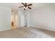 Bedroom with neutral carpet and access to the en-suite bathroom via white paneled doors at 156 Parmelee Dr. # B, Murrells Inlet, SC 29576