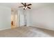 Large carpeted bedroom with ceiling fan, closet, and two doorways to the bathroom and hallway at 156 Parmelee Dr. # B, Murrells Inlet, SC 29576