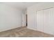 Clean, carpeted bedroom featuring a closet with double doors and a doorway to another room at 156 Parmelee Dr. # B, Murrells Inlet, SC 29576