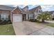 Charming townhome featuring stone accents, neutral siding, and a well-maintained lawn with a private driveway and attached garage at 156 Parmelee Dr. # B, Murrells Inlet, SC 29576