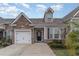 Charming home featuring a stone facade, attached garage, and well-maintained front yard landscaping at 156 Parmelee Dr. # B, Murrells Inlet, SC 29576