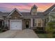 Inviting home featuring a stone facade, one-car garage, and manicured landscaping at 156 Parmelee Dr. # B, Murrells Inlet, SC 29576