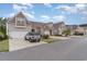 Attractive townhomes showcase stone and siding exteriors with private driveways and garages, set against a partly cloudy sky at 156 Parmelee Dr. # B, Murrells Inlet, SC 29576