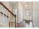 Bright foyer features hardwood floors, a staircase with wooden railing, and a decorative front door at 156 Parmelee Dr. # B, Murrells Inlet, SC 29576