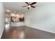 Open-concept living room featuring hardwood floors, a ceiling fan, and a view into the kitchen area at 156 Parmelee Dr. # B, Murrells Inlet, SC 29576