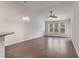 Spacious living room with beautiful hardwood floors, vaulted ceiling, and natural light from large windows at 156 Parmelee Dr. # B, Murrells Inlet, SC 29576