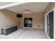 Covered patio with ceiling fan, storage bench, and sliding glass doors to the interior at 156 Parmelee Dr. # B, Murrells Inlet, SC 29576