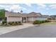 Community pool house with beige siding, stone accents, secure gate, and charming blue doors, surrounded by lush landscaping at 156 Parmelee Dr. # B, Murrells Inlet, SC 29576