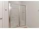 Bright white tile shower with glass door and built-in shelving at 156 Parmelee Dr. # B, Murrells Inlet, SC 29576