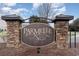 Stone community welcome sign with decorative metal accents and planted mulch bed at 156 Parmelee Dr. # B, Murrells Inlet, SC 29576