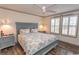 Comfortable bedroom featuring a ceiling fan, wood floors, a queen bed, and two windows at 1668 Greenridge Dr., Conway, SC 29526