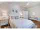 Bright bedroom featuring a ceiling fan, a bed, two nightstands with lamps, and a sitting bench at 1801 Tryon Dr, Myrtle Beach, SC 29588