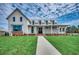 Charming home featuring a manicured lawn, inviting porch, and modern architectural details, creating an elegant curb appeal at 1801 Tryon Dr, Myrtle Beach, SC 29588