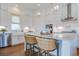 Modern kitchen featuring an island with marble countertops, stainless steel appliances, and stylish wicker chairs at 1801 Tryon Dr, Myrtle Beach, SC 29588