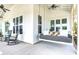 Inviting porch featuring a cozy daybed swing and comfortable rocking chairs at 1801 Tryon Dr, Myrtle Beach, SC 29588