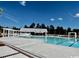 Large swimming pool with bright blue water and surrounding concrete deck, perfect for relaxing and enjoying the outdoors at 1801 Tryon Dr, Myrtle Beach, SC 29588