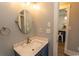 Bathroom featuring a blue vanity, white countertop, a decorative mirror and new fixtures at 201 N 76Th Ave. N # B-2, Myrtle Beach, SC 29572