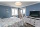 This bedroom features blue walls, light colored furniture, and sliding doors to the outside at 201 N 76Th Ave. N # B-2, Myrtle Beach, SC 29572