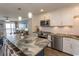 Modern kitchen featuring white cabinetry, stainless steel appliances, and a large center island with seating at 201 N 76Th Ave. N # B-2, Myrtle Beach, SC 29572