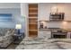 Well-lit kitchen featuring white cabinets, stainless steel appliances, and a large center island with open shelving at 201 N 76Th Ave. N # B-2, Myrtle Beach, SC 29572