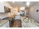 Bright kitchen featuring white cabinets, stainless steel appliances, and a large center island with marble countertops at 201 N 76Th Ave. N # B-2, Myrtle Beach, SC 29572