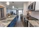 Bright kitchen flows into living area, featuring stainless appliances and a large island at 201 N 76Th Ave. N # B-2, Myrtle Beach, SC 29572