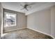 Bedroom with tile flooring, neutral paint, a ceiling fan, and a bright window at 2151 Clearwater Dr. # C, Surfside Beach, SC 29575