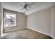 Well lit bedroom featuring tile flooring, ceiling fan and a large window at 2151 Clearwater Dr. # C, Surfside Beach, SC 29575