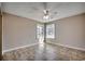 Well-lit bedroom with two windows and a ceiling fan at 2151 Clearwater Dr. # C, Surfside Beach, SC 29575