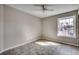Bright bedroom with tile flooring, ceiling fan, and large window with outside view at 2151 Clearwater Dr. # C, Surfside Beach, SC 29575