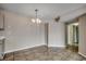 Bright dining room features tile flooring and a decorative chandelier at 2151 Clearwater Dr. # C, Surfside Beach, SC 29575