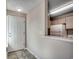 Hallway with tile flooring that leads to a galley-style kitchen featuring white appliances at 2151 Clearwater Dr. # C, Surfside Beach, SC 29575