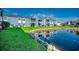 Scenic view of blue condos reflecting in a tranquil pond with lush landscaping at 2151 Clearwater Dr. # C, Surfside Beach, SC 29575