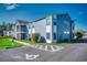 Attractive two-story condo featuring blue siding, and a well maintained landscaped yard at 2151 Clearwater Dr. # C, Surfside Beach, SC 29575