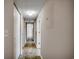 Hallway with tile flooring, neutral paint, and multiple closets, providing ample storage at 2151 Clearwater Dr. # C, Surfside Beach, SC 29575