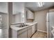 Galley kitchen area with white appliances and a breakfast bar overlooking the living area at 2151 Clearwater Dr. # C, Surfside Beach, SC 29575