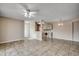 Open concept living area flows into the kitchen with tile flooring and a ceiling fan at 2151 Clearwater Dr. # C, Surfside Beach, SC 29575