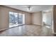 Open living area with tile flooring, sliding glass door to back patio, and entryway to the left at 2151 Clearwater Dr. # C, Surfside Beach, SC 29575