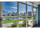 Enclosed screened porch with peaceful views of the pond and lush landscaping at 2151 Clearwater Dr. # C, Surfside Beach, SC 29575