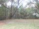 A large backyard features trees, natural landscaping and partial fencing around the property at 223 Greentown Rd., Georgetown, SC 29440