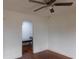 Bright bedroom featuring hardwood floors, a ceiling fan, and a bench seat in the hallway at 223 Greentown Rd., Georgetown, SC 29440