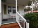 Inviting front porch with white railings, red brick steps and greenery at 223 Greentown Rd., Georgetown, SC 29440