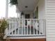 Inviting front porch with white railings and a chairs at 223 Greentown Rd., Georgetown, SC 29440