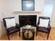 Cozy living room with a decorative fireplace, hardwood floors, and comfortable seating arrangement at 223 Greentown Rd., Georgetown, SC 29440