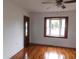 Inviting living room featuring hardwood floors, a bay window, and a classic ceiling fan at 223 Greentown Rd., Georgetown, SC 29440