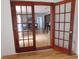 An open view from one room through wood-framed doors into a living room at 223 Greentown Rd., Georgetown, SC 29440